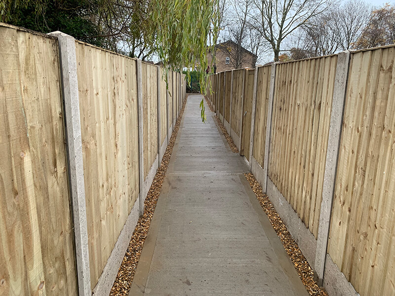 Concrete posts with wooden fence panels